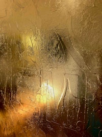 a frosted glass window with a light shining through it