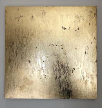 a gold painting on a white wall